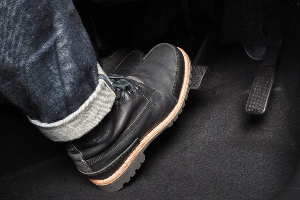 Accelerator and breaking pedal in a car. Close up the foot pressing foot pedal of a car to drive ahead. Driver driving the car by pushing accelerator pedals of the car. inside vehicle.